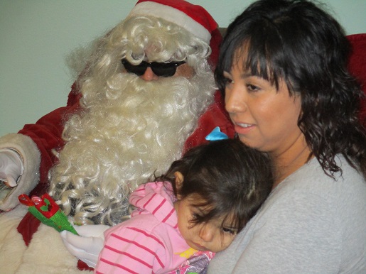 Santa posing with a mother and daughter